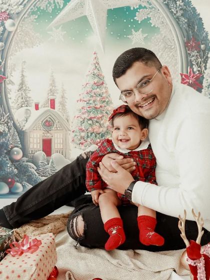 A precious moment between father and daughter. Their happy smiles during this winter wonderland themed Christmas shoot are just heartwarming.