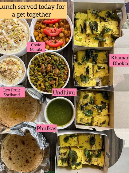 A lunch get-together meal with Undhiyu, Chole Masala, Khaman Dhokla, Phulkas, and Dry Fruit Shrikhand.