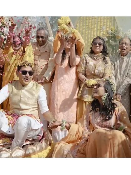 A beautiful moment from the Haldi ceremony, where the couple is showered with flower petals by their happy family.