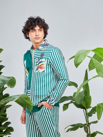 A full view of the green and white striped co-ord set. The floral pocket detail adds a quirky touch to this already intriguing and stylish ensemble.