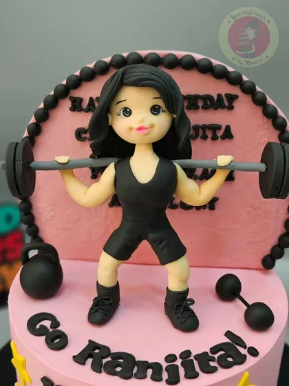 Go Ranita! A customized cake for a professional weightlifter, featuring a strong fondant figurine lifting weights. This cake is all about celebrating strength and dedication.