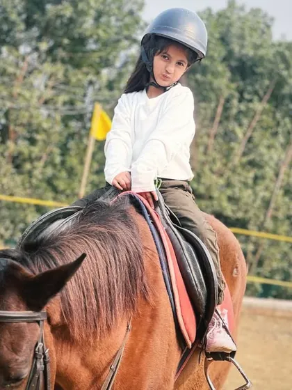 A candid portrait of a young girl on her horse. These natural moments often make for the most cherished photographs.