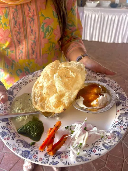 A guest's plate filled with a variety of treats from my Republic Day brunch, including chole bhature and dahi vada. I aim to provide a spread with something for everyone to enjoy.