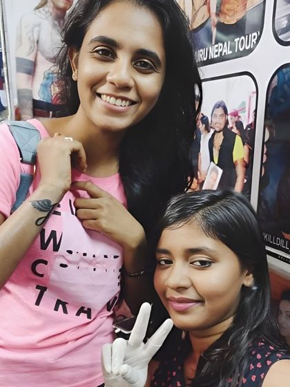 My artist with a happy client showing off her new feather tattoo.