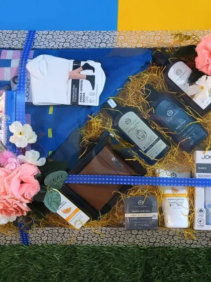 A men's grooming and essentials hamper, containing The Body Shop products, Jockey innerwear, a wallet, and other items.