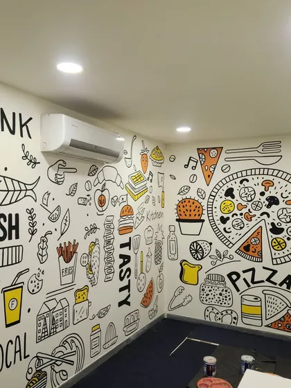 A full-wall food-themed doodle is the perfect way to express a cafe's personality. This black and white mural with pops of color is filled with fun illustrations that highlight the fresh, local ingredients and tasty offerings of the establishment.