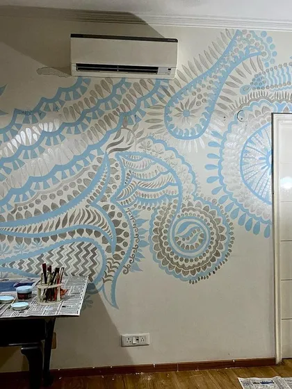 Not all my work is a riot of color. This mural, 'The Subtle Charm of Delhi,' uses a gentle palette of aqua blue and silver to create a serene and mesmerizing effect. It proves that art can be both impactful and easy on the eyes, bringing a quiet elegance to any room.