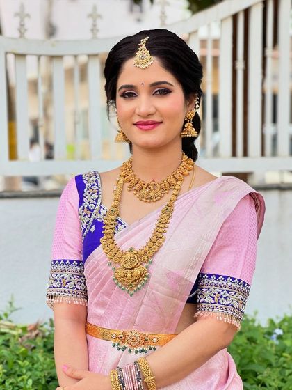 Soundarya looking elegant for a naming ceremony. Her pink Kanjivaram saree is paired with classic gold jewelry and a soft, pretty makeup look.