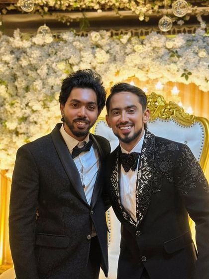 Suited up and looking sharp. These gentlemen are ready for a wedding celebration in our stylish black suits and tuxedos.