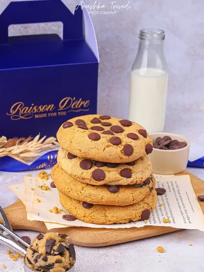 A classic stack of chocolate chip cookies next to a bottle of milk. This shot evokes a sense of nostalgia and simple, comforting goodness.