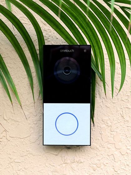 This Onetouch video door phone, set against a textured wall with natural elements, shows our commitment to discreet security. See and speak to visitors from your phone, ensuring you are always in control of who enters your home.