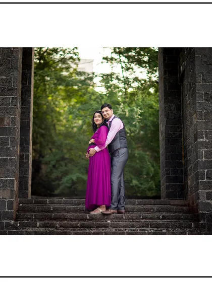 A beautiful, framed shot of the couple standing in a stone archway, creating a classic and elegant portrait.