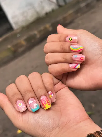 For when you want your nails to be the life of the party. This fun, mismatched set features hand-painted retro rainbows, smiley faces, clouds, and flames for a totally unique and playful look.
