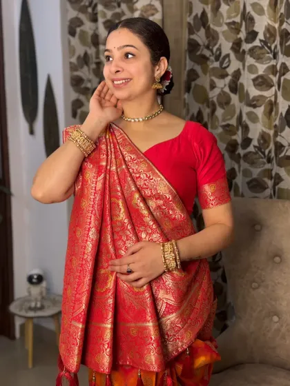 A joyful and radiant pose in a traditional saree. The makeup enhances her natural smile, with a focus on clean skin and classic gold jewelry.