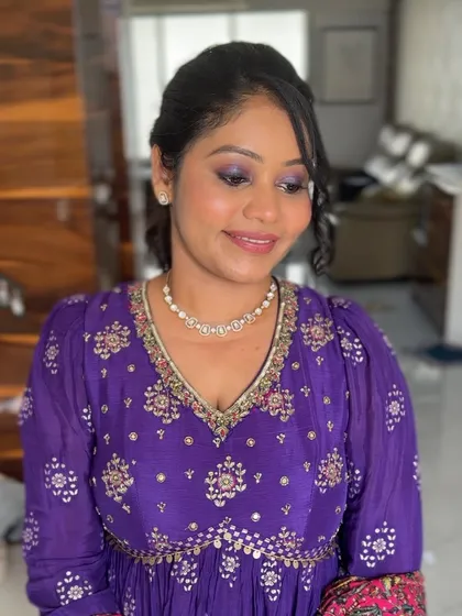 Eyes closed, you can see the soft application of the purple shimmer, which adds a festive touch without being too heavy.