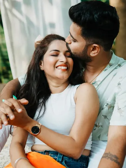 A tender forehead kiss. This close-up shot captures a moment of pure affection during a picnic-themed pre-wedding shoot.