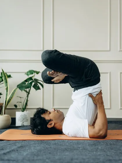 Urdhva Padmasana in Sarvangasana (Upward Lotus in Shoulder Stand). This advanced variation combines the benefits of an inversion with a deep hip opener, requiring both flexibility and balance.