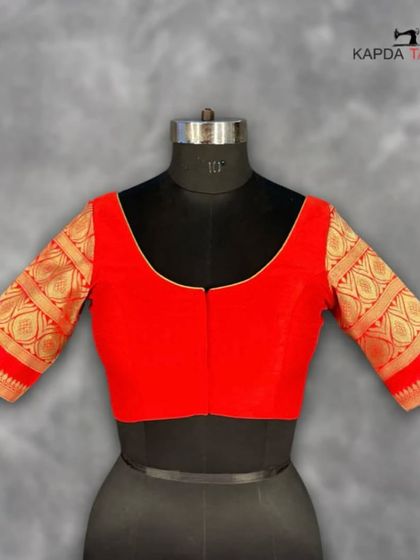 This vibrant red brocade blouse is designed to give you a confident look. The rich texture and deep red shade flatter every skin tone, making it a perfect choice for festive occasions.