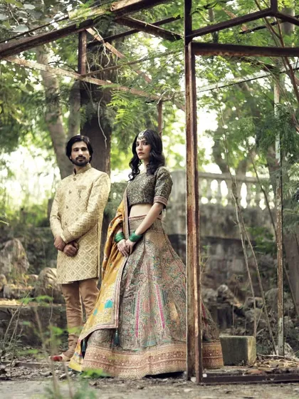 The couple framed in a rustic setting, showcasing our outfits that blend perfectly with natural and creative photoshoot concepts.
