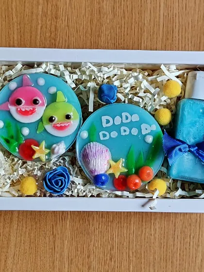 The Baby Shark gift set, beautifully packaged in a white gift box with colorful accents.