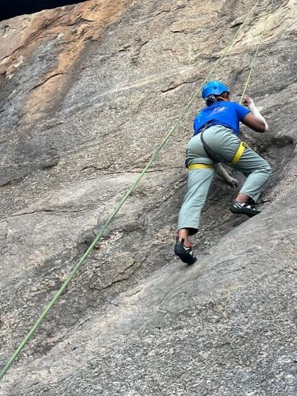 A climber uses precise movements to ascend a route during a top-rope session.