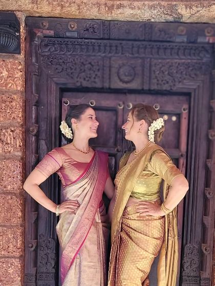 A beautiful moment between a German mother and daughter, both draped in traditional silk sarees for a South Indian wedding.