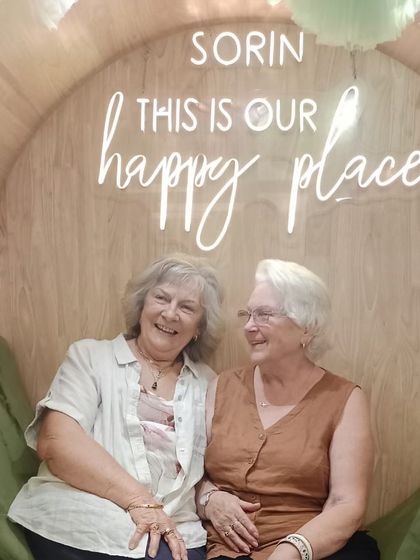 Two friends sharing a laugh after their spa treatments. Our salon is a perfect place for friends to catch up and relax together.