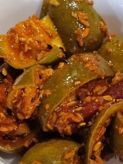 A bowl of my traditional Punjabi mango pickle. This is a classic recipe with whole spices and dried red chilies, giving it a rich and authentic taste. It is made without any preservatives, just like at home.