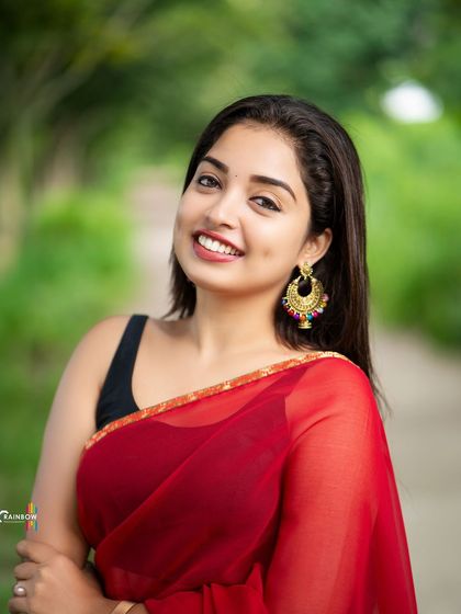 Another variation from the red saree shoot, this one a classic, happy portrait that radiates positivity.