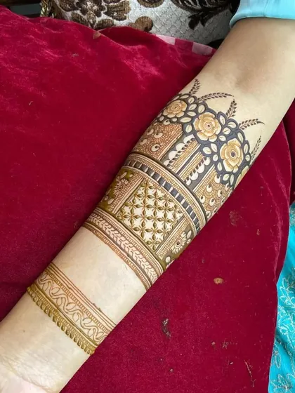 A close up of a beautiful floral band on the arm. The shading and detail in the roses give them a three dimensional appearance.