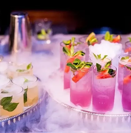 Trays of our colorful cocktails served amidst a cloud of smoke. This method of service ensures that drinks arrive at your guests with a touch of theatre, making the experience interactive and photo-worthy.