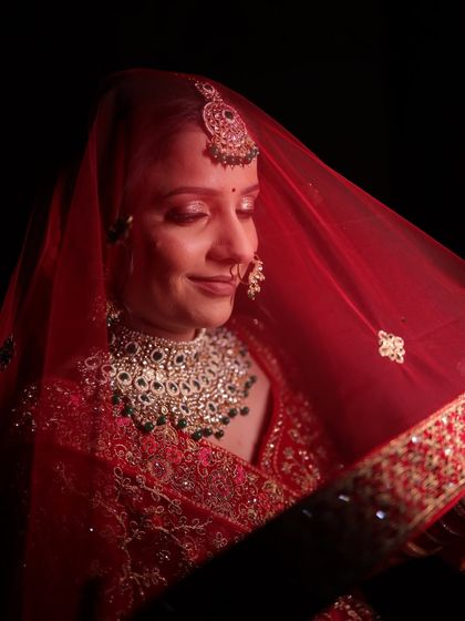 Urvashi's subtle and natural bridal look. We focused on soft, shimmery eyes and flawless skin to complement her gorgeous red lehenga and emerald jewellery.