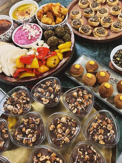Here’s a little preview of how I can make your hosting duties easy and delicious. This spread features a mix of my Mediterranean appetizers, bite-sized desserts, and savory snacks, all made from scratch for your party.