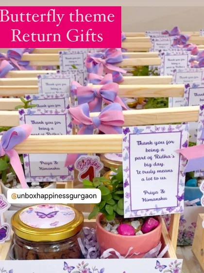 This image highlights the "Butterfly theme Return Gifts" with their custom number "1" tags and beautiful floral-print baskets.