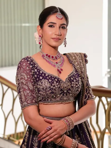 A close-up of the bride Namrata's reception look. The deep purple velvet blouse with intricate embroidery pairs beautifully with the ruby and diamond necklace, creating a look of pure bahurani elegance.