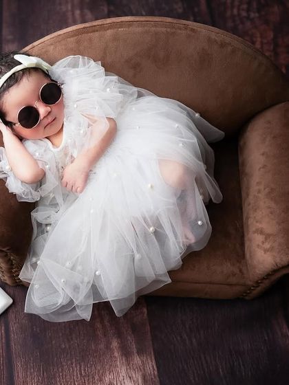 "Hey, all good?" This six day old diva is already a star, lounging on her miniature couch in a gorgeous tulle dress and sunglasses. I just love creating these beautiful setups.