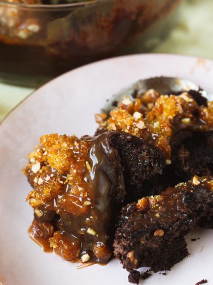 A messy, delicious spoonful of my Chocolate & Salted Caramel Trifle, showing the gooey caramel, rich cake, and crunchy almond praline.
