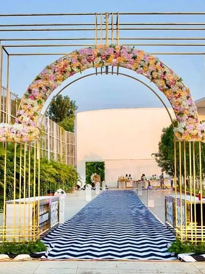 This modern metal archway was fabricated by our team to create a stunning entrance for an outdoor reception.