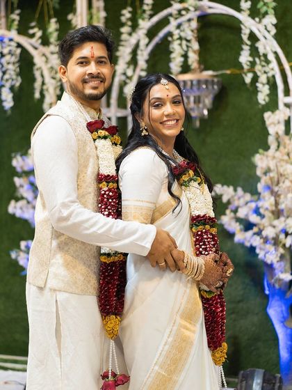 A smiling portrait of the happy couple. The bride's simple yet elegant look is perfect for a modern Christian wedding ceremony.