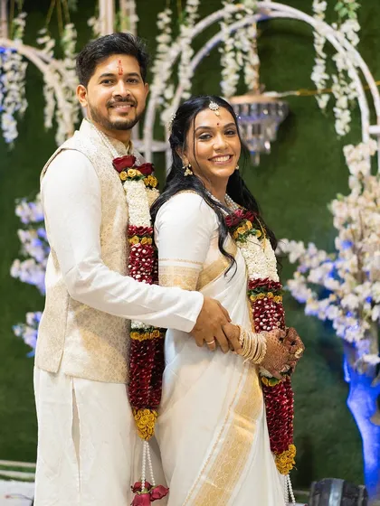 A smiling portrait of the happy couple. The bride's simple yet elegant look is perfect for a modern Christian wedding ceremony.