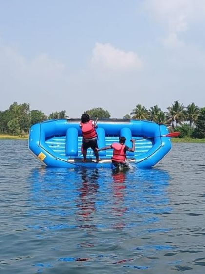 Two participants work together to right a flipped raft, putting their training into practice in the water.