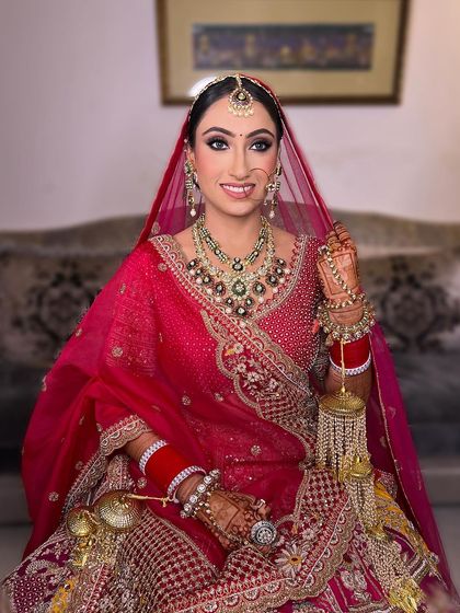 The smile of a confident bride. This look combines traditional elements with modern makeup techniques to create a style that is both timeless and fresh.