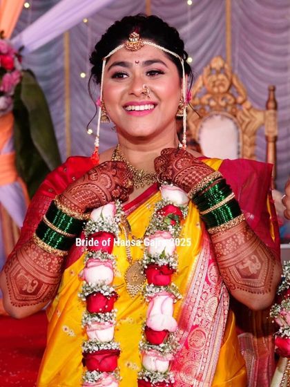 A radiant Maharashtrian bride during her wedding ceremony. Her joyful expression and traditional attire, complete with beautiful mehendi, capture the essence of her culture.