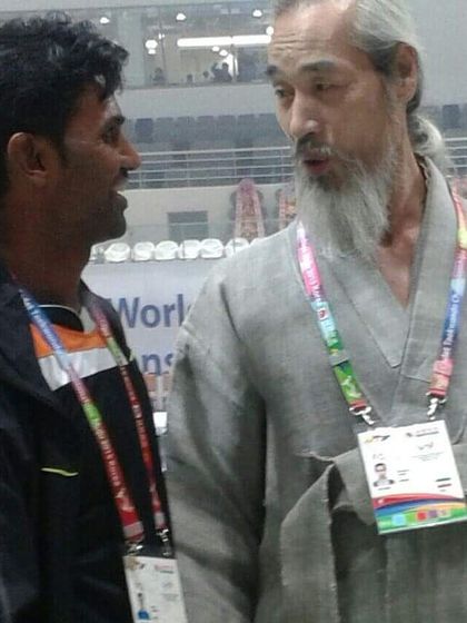 In conversation with a respected Taekwondo Grand Master at a world championship event. Learning from the experience of elders is a core part of martial arts.