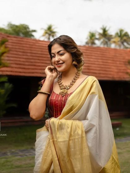 A happy, candid moment with Anusree. The drape holds its shape perfectly, showcasing the importance of professional saree styling for shoots.