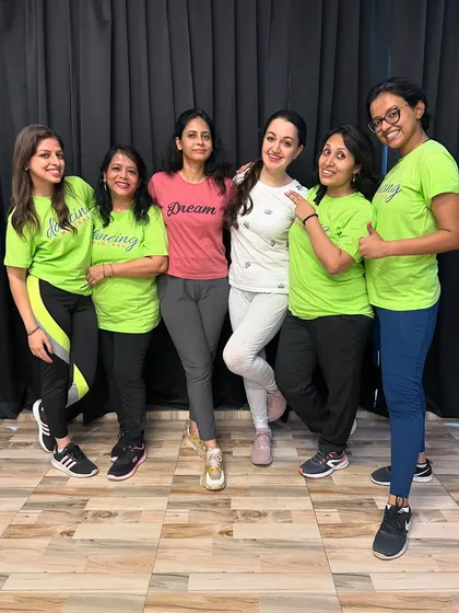 The 'Dancing Diva's' with their mentor, ready to own the stage. We support our students every step of the way.