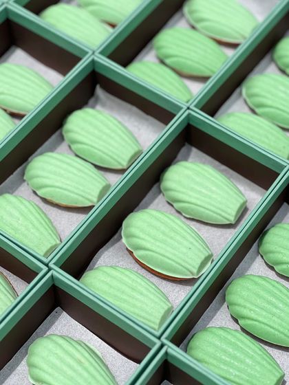 The custom desserts we created for The Face Shop. These delicate madeleines were coated in a light green chocolate to match their brand's aesthetic, showcasing our ability to create themed treats for corporate partners.
