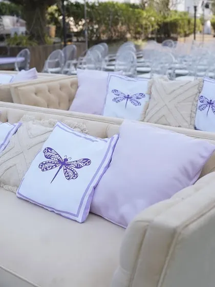 Custom-printed cushions with a dragonfly motif, matching the lavender color scheme of Reeya and Parth's wedding.