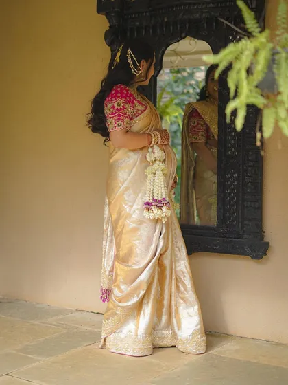 A beautiful, reflective shot of the mother-to-be looking into a traditional mirror.