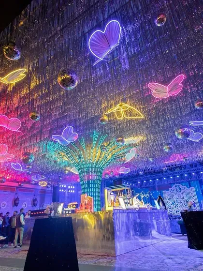 Another view of the neon butterfly ceiling, showing how the colors and lights create a dynamic and electrifying atmosphere for a party.